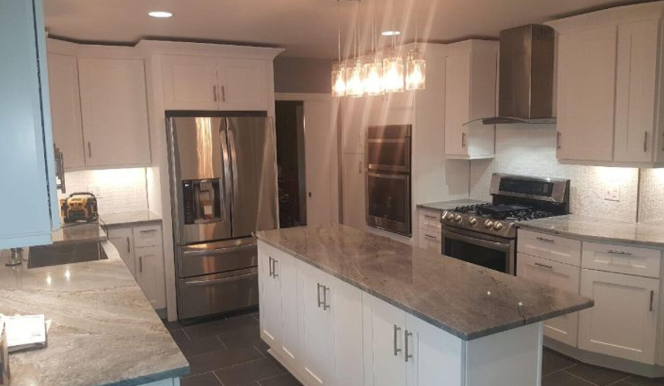 White kitchen with island, pendant lights, and stainless appliances, JL Home Builders, Pittsburgh