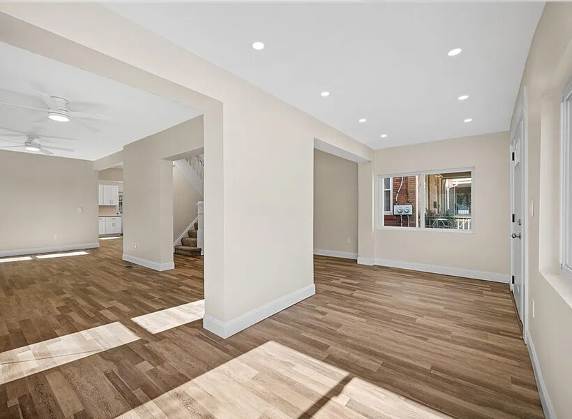Spacious interior of a recently remodeled home featuring light-colored walls, hardwood flooring, and ample natural light, illustrating the transformation capabilities of JL Home Builders in whole home renovations.