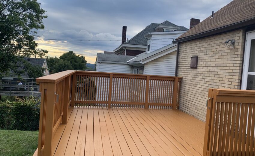 Stained wood deck with railings built by JL Home Builders, photo 2