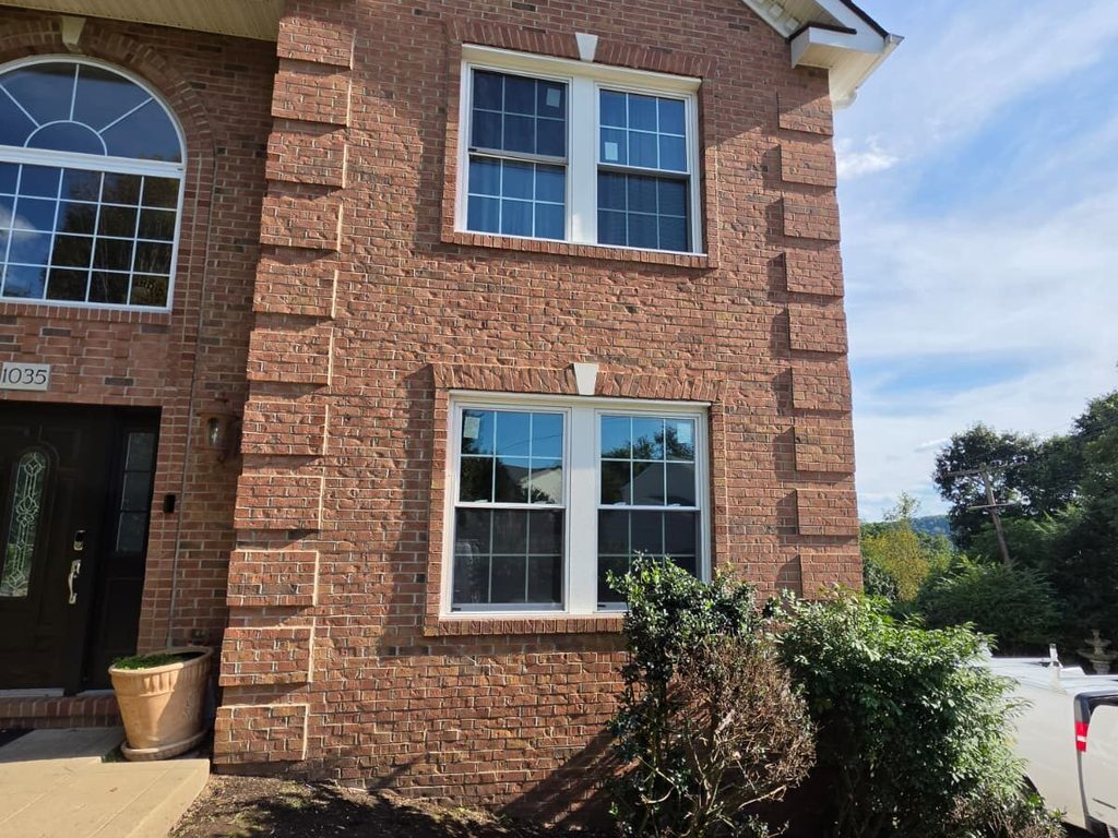 Brick Pittsburgh home exterior with new white windows, JL Home Builders