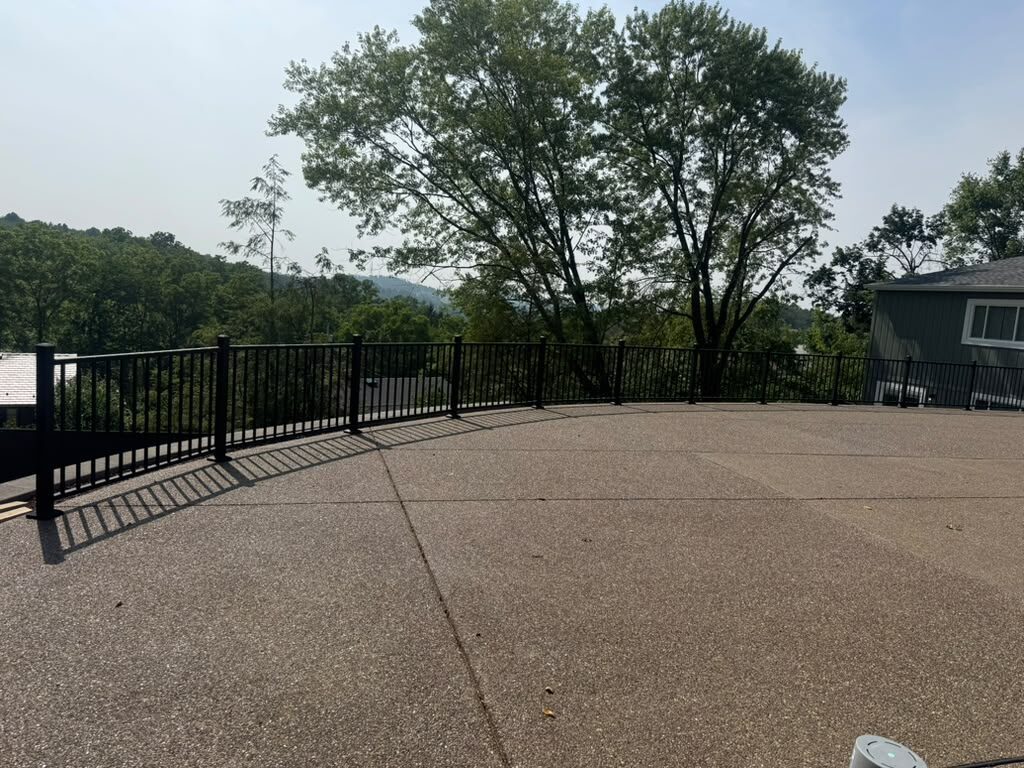 Curved black aluminum railing on an exposed aggregate patio, JL Home Builders, Pittsburgh