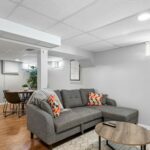 Finished basement living room with fireplace and sofa