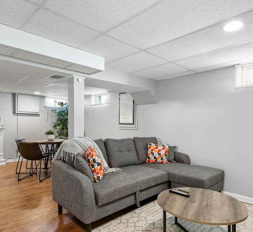 Finished basement living room with fireplace and sofa