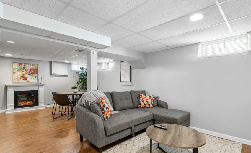 Finished basement living room with fireplace and sofa