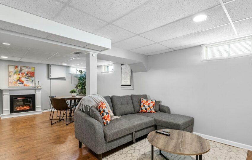 Finished basement living room with fireplace and sofa
