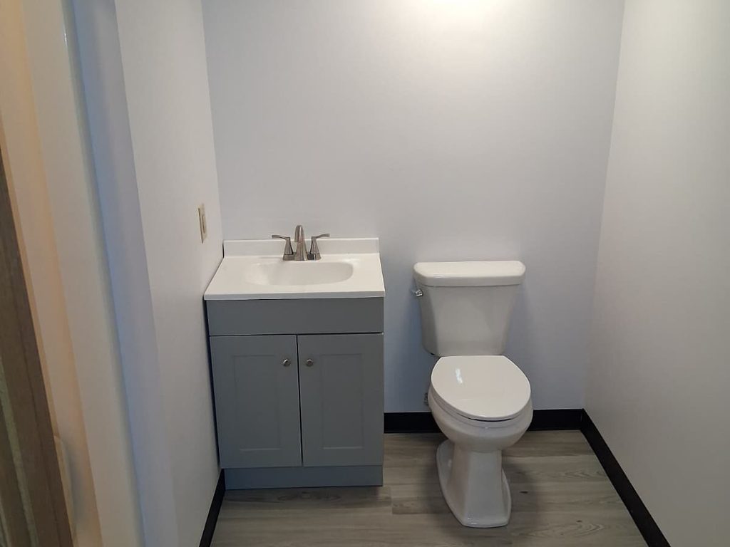 Finished bathroom with gray vanity and toilet, JL Home Builders, Pittsburgh