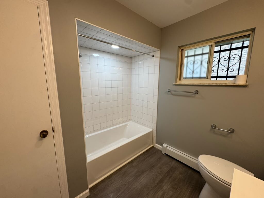 Finished bathroom with white tile tub surround, JL Home Builders, Pittsburgh