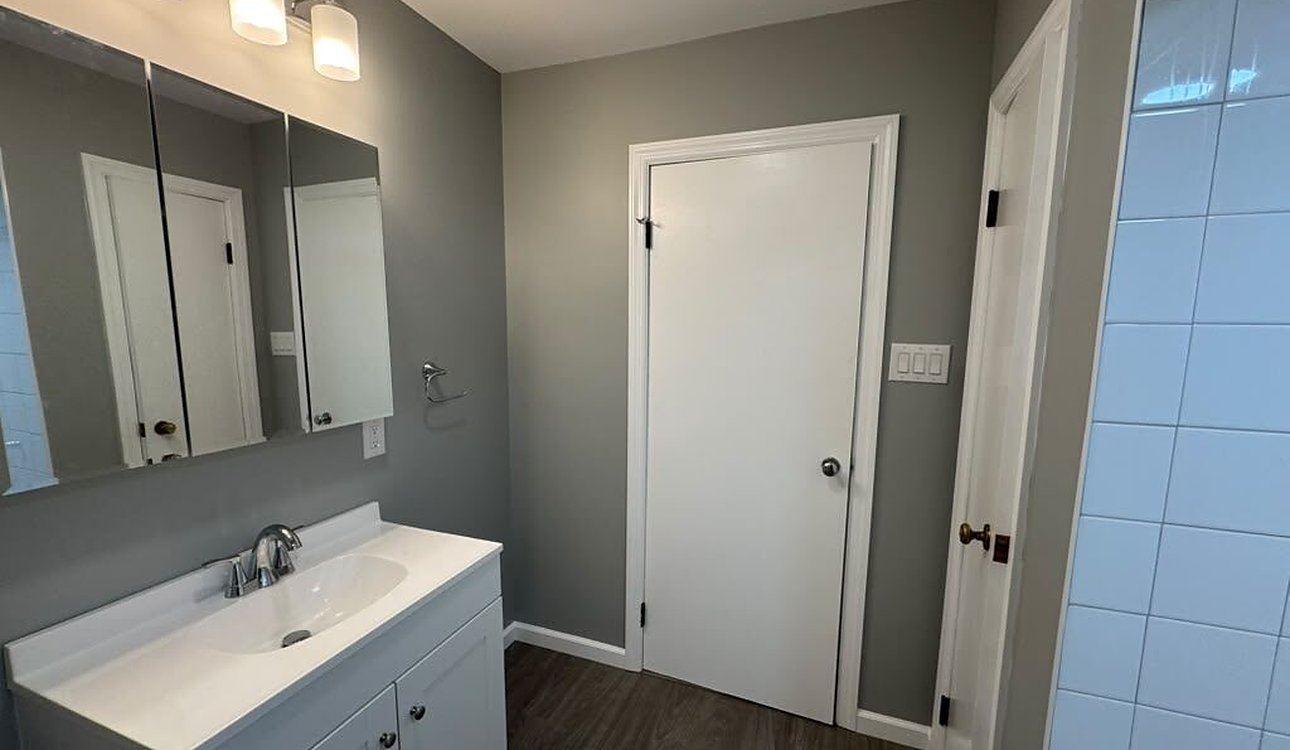 Finished Gray Bathroom With White Vanity by JL Home Builders, Pittsburgh