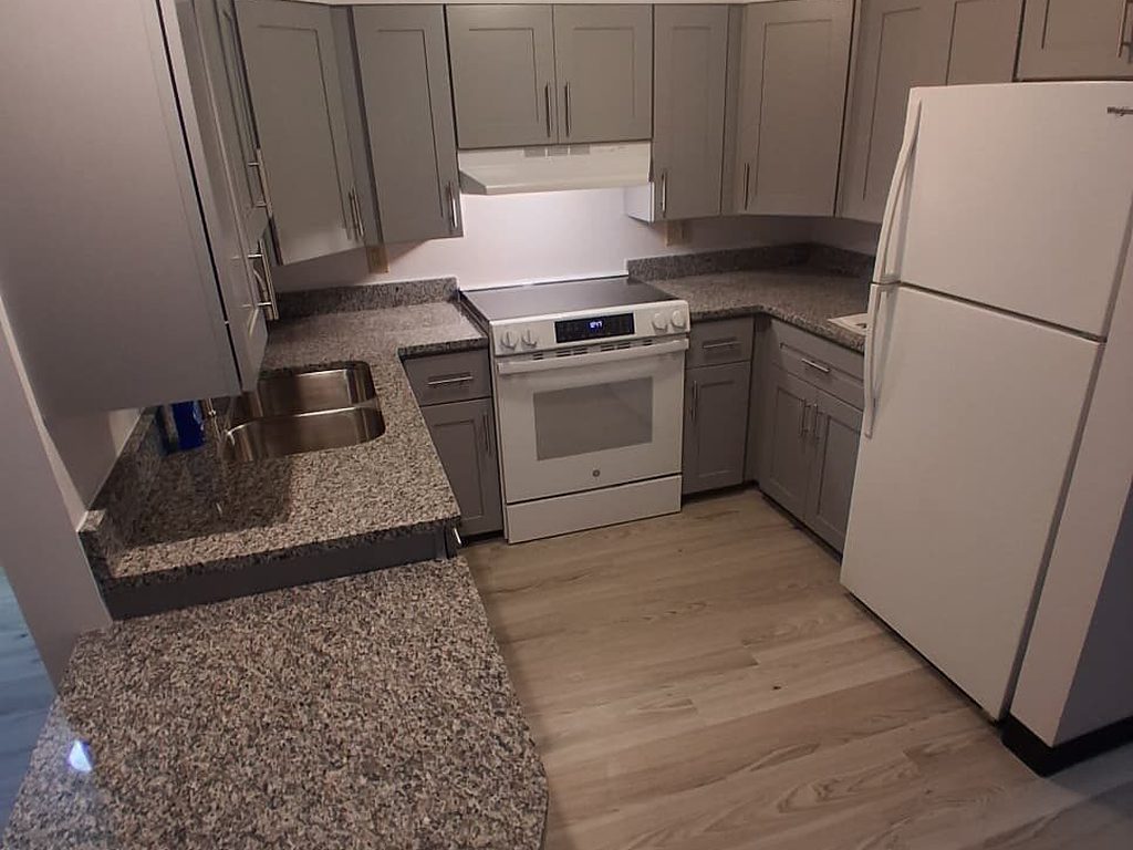 Finished gray kitchen with a granite peninsula, JL Home Builders, Pittsburgh
