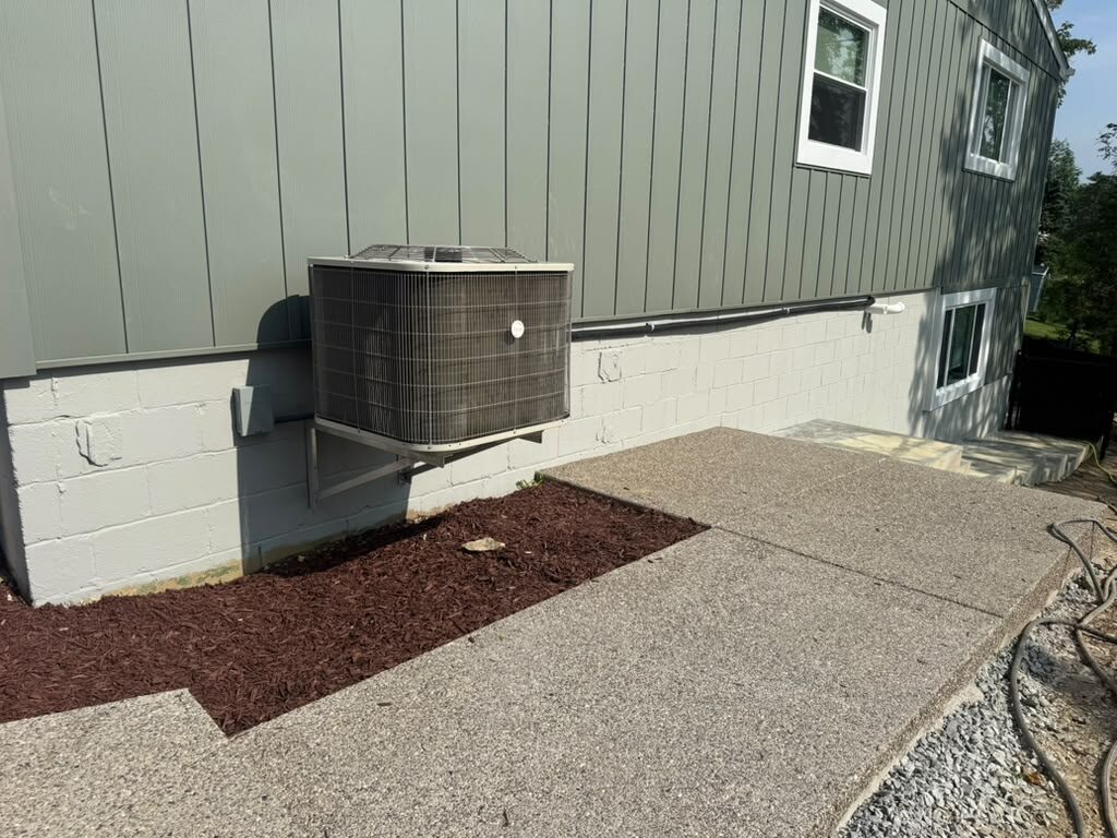 Finished green siding with a new concrete patio and mulch bed, JL Home Builders, Pittsburgh