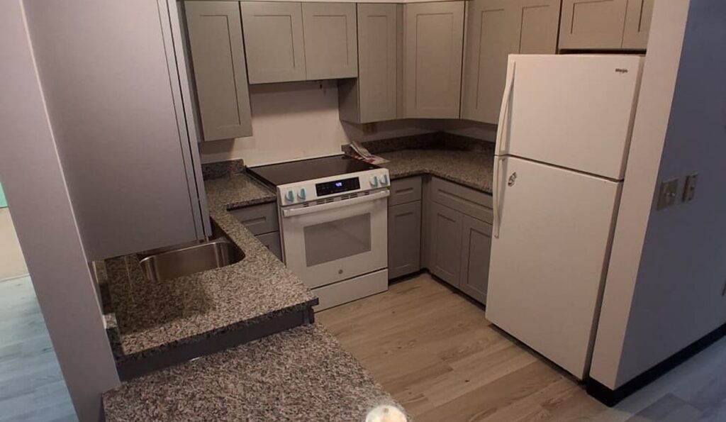 Finished kitchen with granite peninsula and refrigerator, JL Home Builders, Pittsburgh
