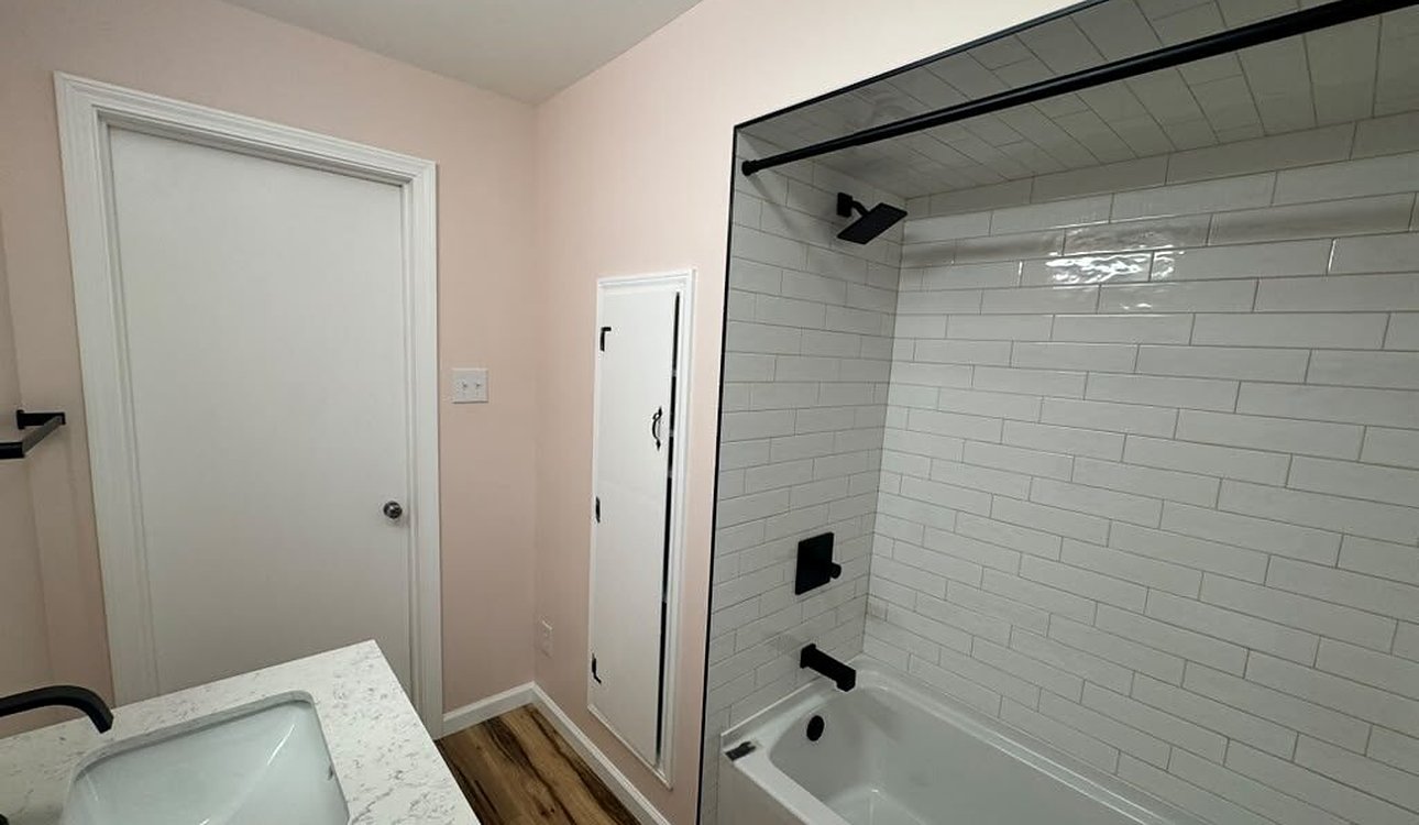 Finished Subway Tile Tub With Black Fixtures by JL Home Builders, Pittsburgh