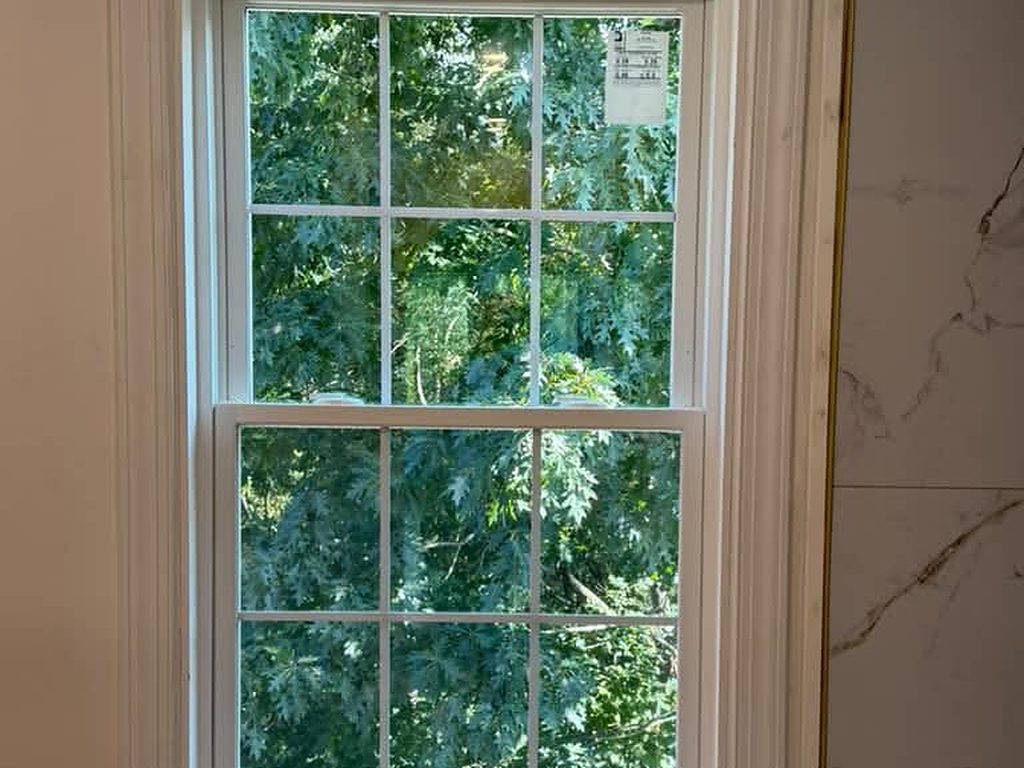 Finished window with new trim beside marble tile, JL Home Builders, Pittsburgh
