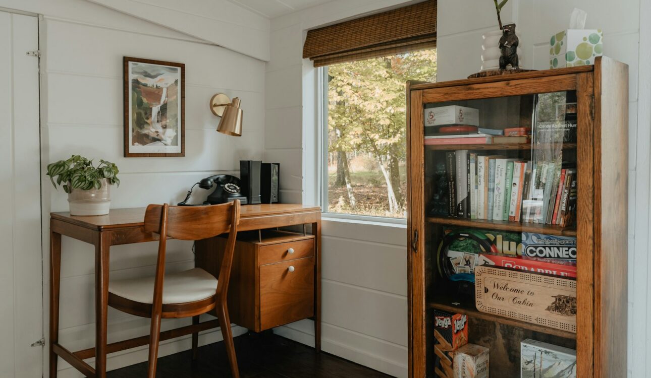Home office with a wood desk beside a window