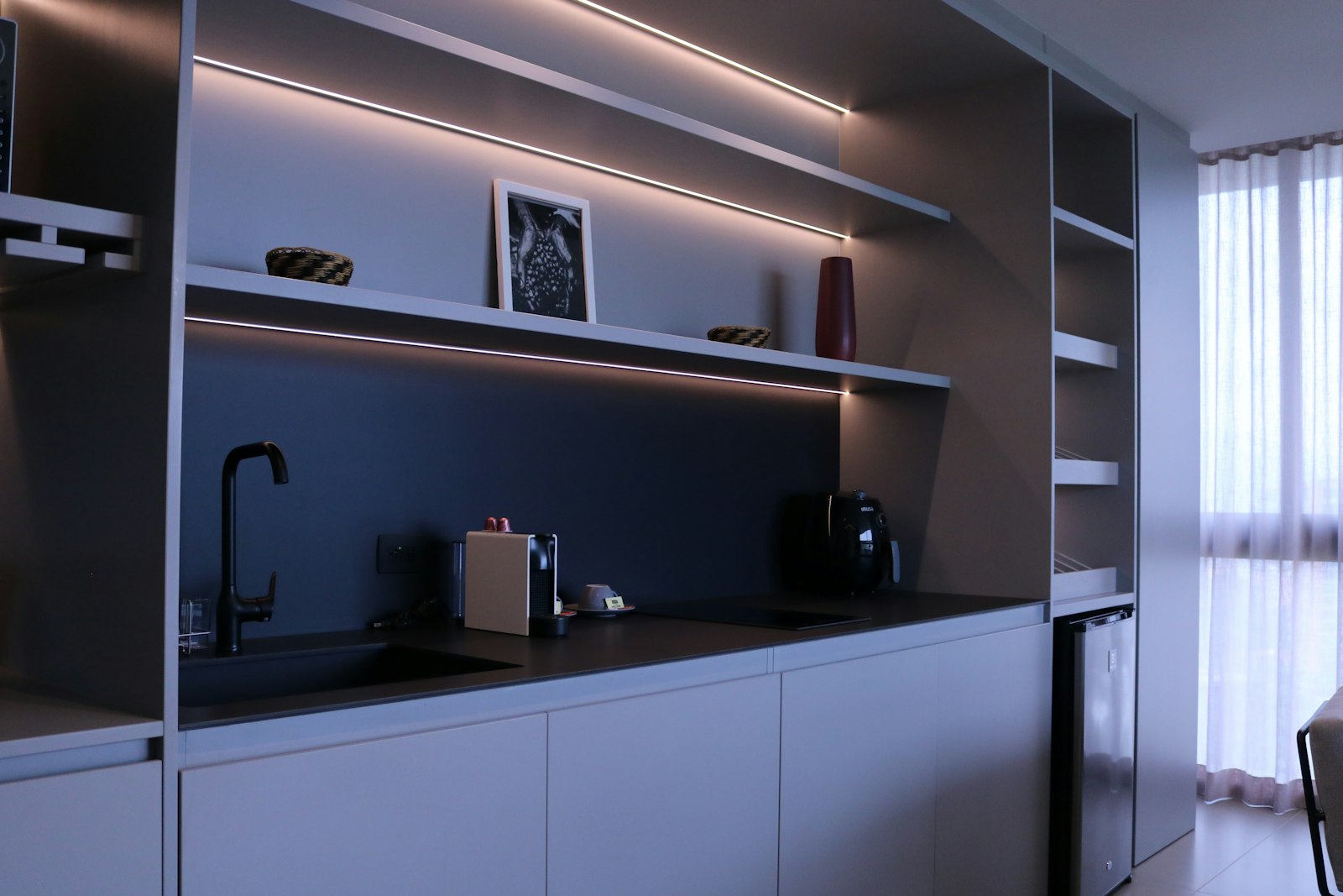 Kitchen with layered lighting over the counters in the evening