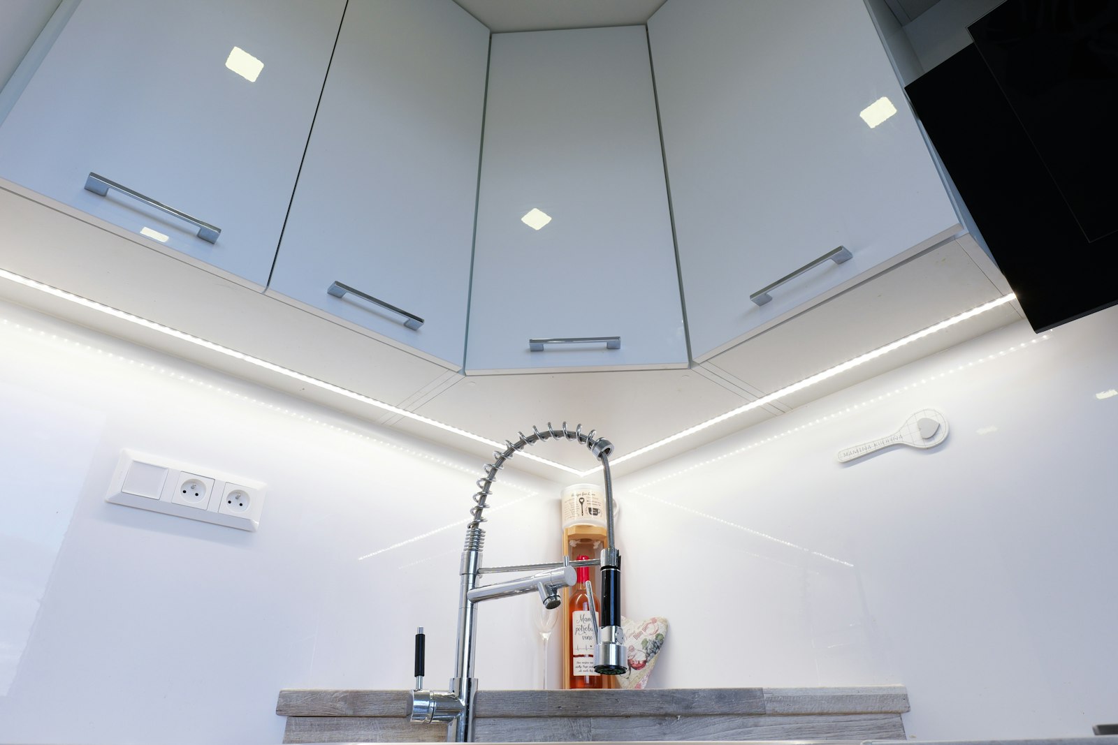 White kitchen with under-cabinet lighting on the counters