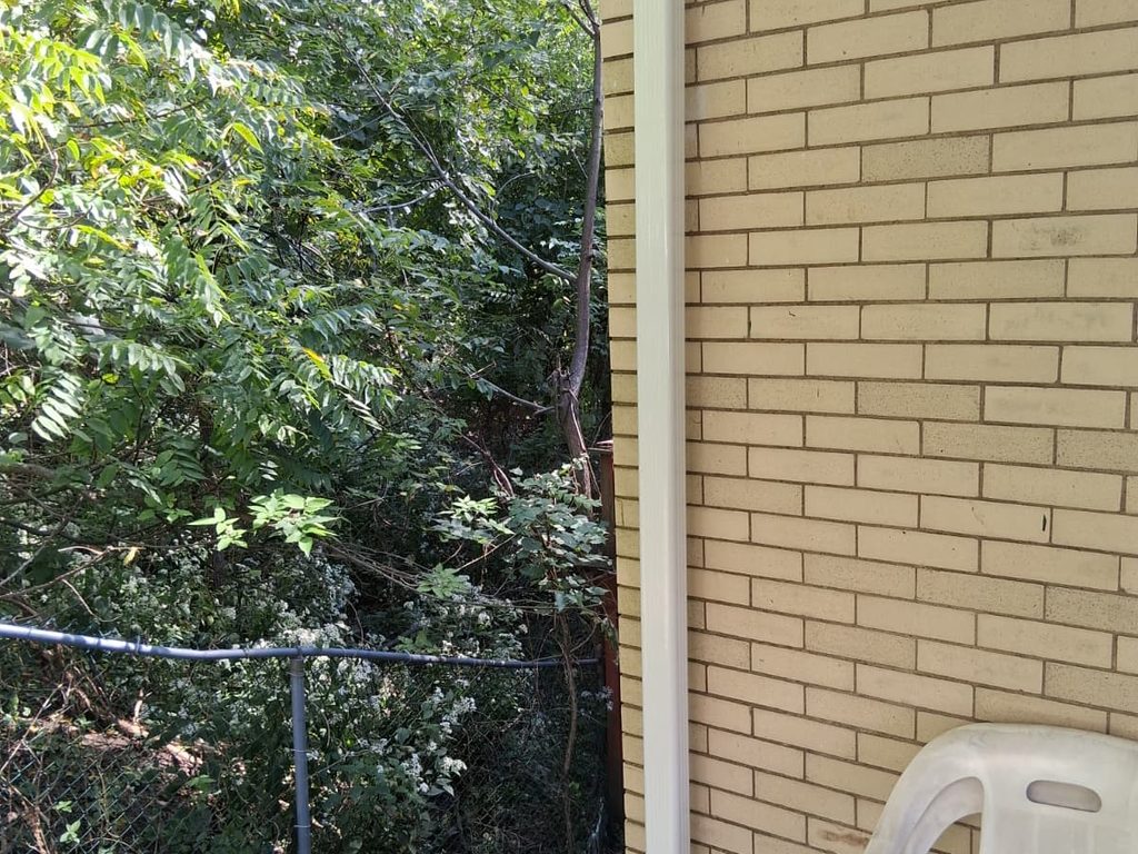 New white downspout on a brick house corner, JL Home Builders, Pittsburgh