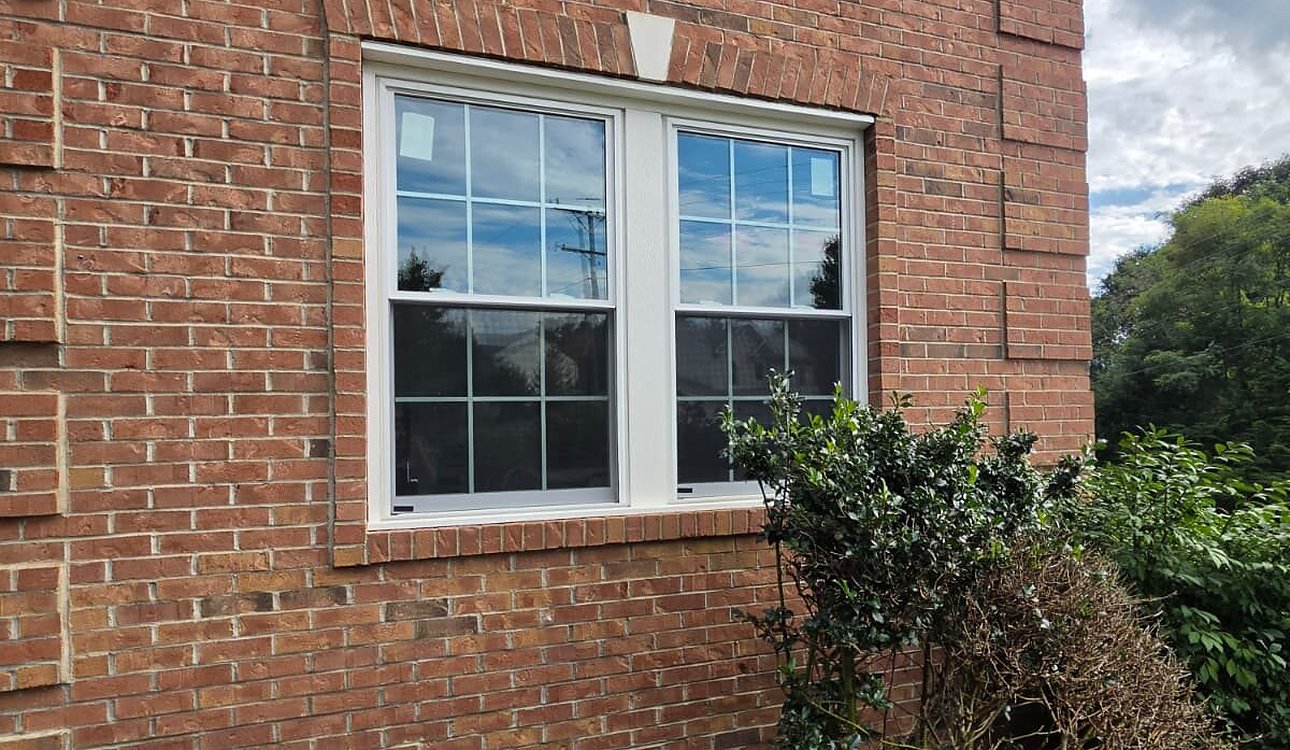 New White Windows Installed In Brick Exterior by JL Home Builders, Pittsburgh