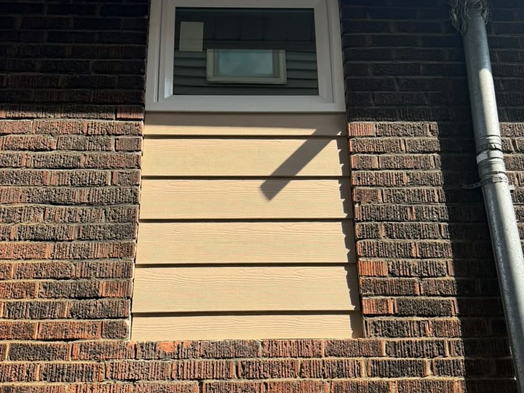 New window set into a brick wall with siding infill, JL Home Builders, Pittsburgh