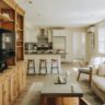 Open concept living room flowing into a kitchen with built-in shelving