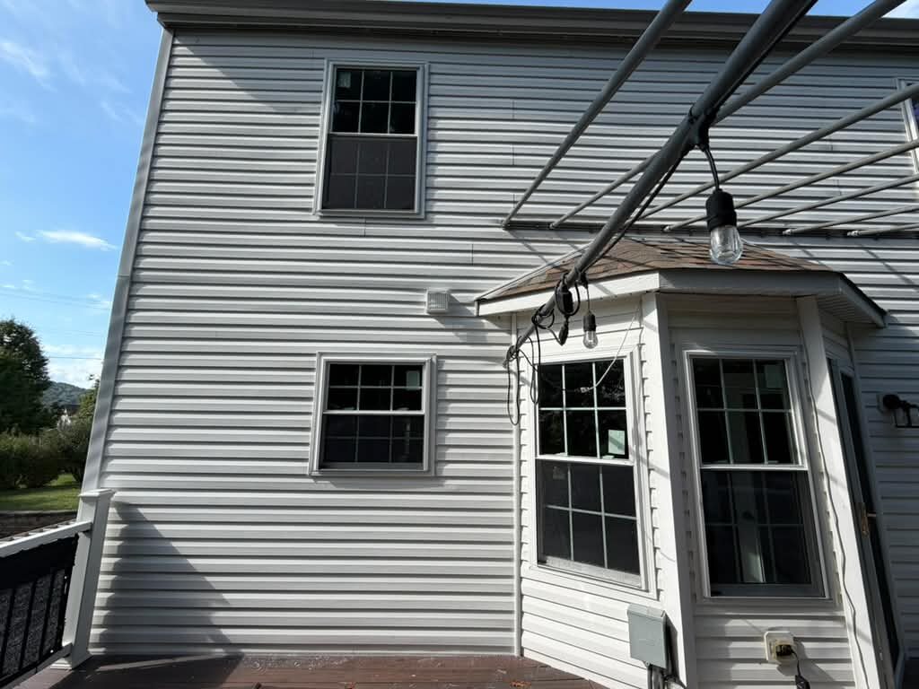 Rear exterior of a Pittsburgh home with new windows and siding, JL Home Builders