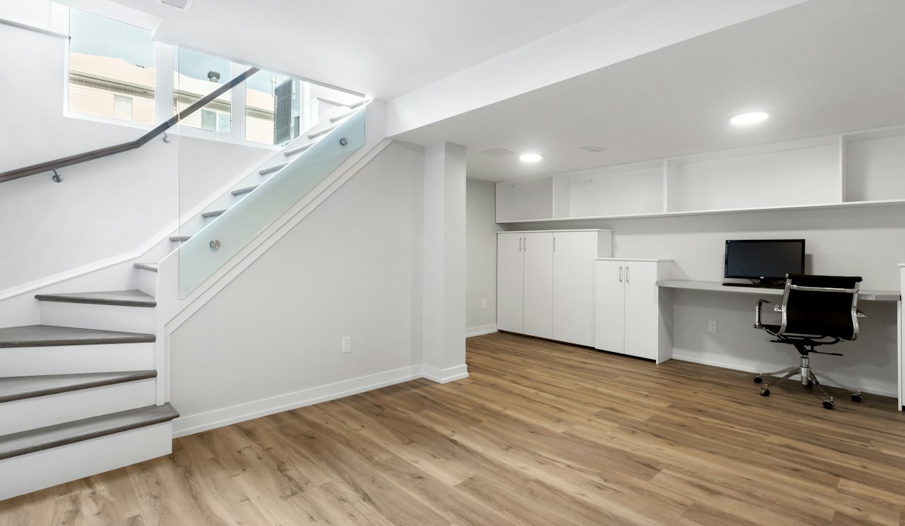 Remodeled basement with staircase and home office nook