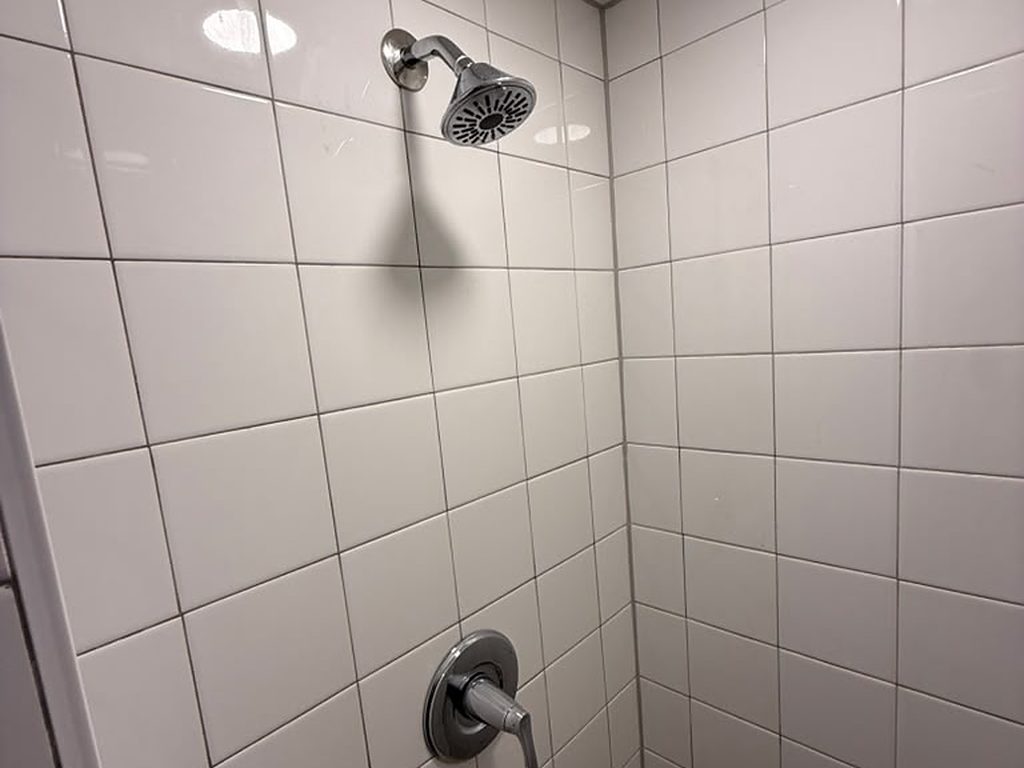 Tiled shower with chrome showerhead and valve trim, JL Home Builders, Pittsburgh