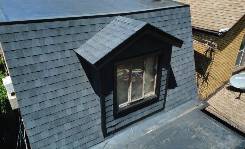 New shingles on a dormer and mansard roof next to a new flat roof