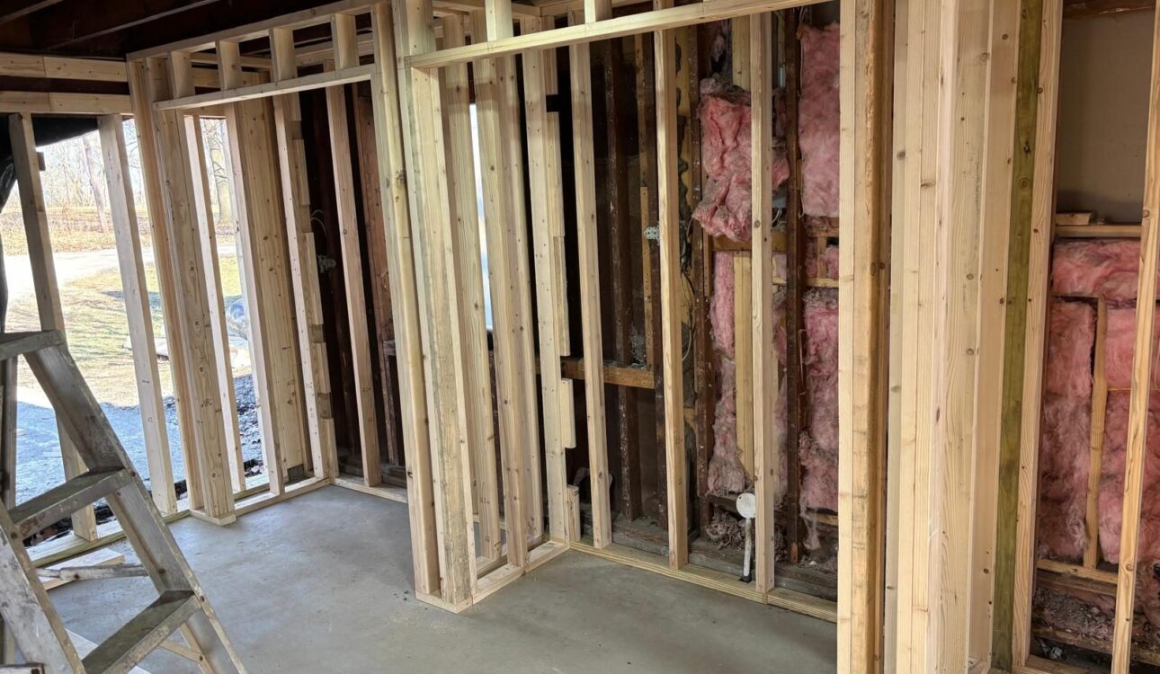 New wood stud framing for interior walls with insulation in the exterior wall