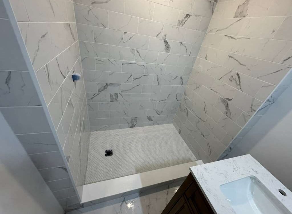 Tiled walk-in shower with a low curb and marble look wall tile, JL Home Builders, Pittsburgh
