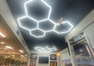 Custom hexagonal LED ceiling design in Shop 724 Barbershop, featuring modern lighting and a stylish interior atmosphere.