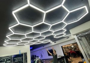 Custom hexagonal LED ceiling installation at Shop 724 Barbershop in Irwin, PA, showcasing modern lighting design and professional ambiance for barbers and clients.