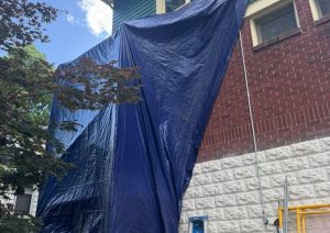 Blue tarp covering the open wall while work continued