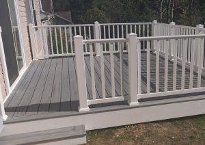 Two-tone composite deck featuring gray decking and custom white railings, designed for low maintenance and modern aesthetics in a Pittsburgh home.