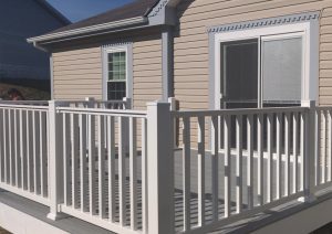 Two-tone composite deck with gray flooring and custom white railings, showcasing a modern design for outdoor living at a Pittsburgh home.