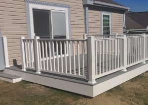 Two-tone composite deck featuring gray decking and custom white railings, designed for a low-maintenance outdoor space in Pittsburgh.