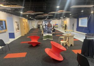 Museum floor with red seating, display walls and recessed lighting