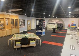 Exhibit hall with map table, display cases and a runway stripe