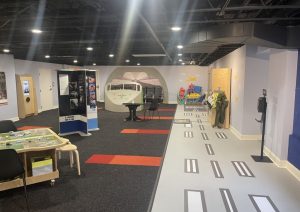 Runway stripe leading past display cases and a cockpit exhibit