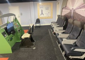 Flight simulator station and airline seats in the aviation museum