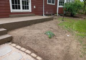 Exposed aggregate concrete steps and landing outside French doors