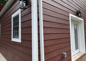 Exposed aggregate concrete landing with lights and siding