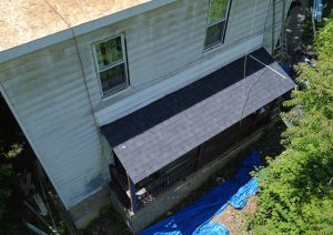 New dark shingle roof on a two story house with a chimney