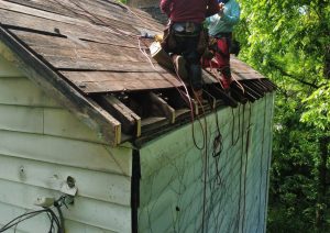 New plywood decking installed next to the chimney before underlayment