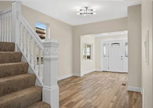 Modern entryway with new flooring, fresh paint, updated trim, and contemporary lighting in a renovated Etna home by JL Home Builders.