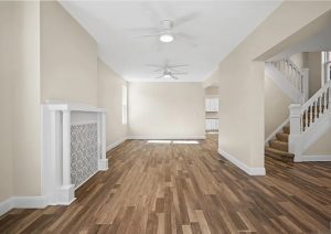 Bright, modern living room with new wood flooring, fresh paint, and updated trim, showcasing a complete home renovation in Etna by JL Home Builders.