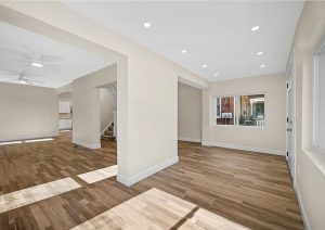 Bright, modern interior of a renovated home in Etna featuring new flooring, neutral tones, and updated lighting, showcasing the transformation by JL Home Builders.